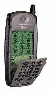 An old-fashioned mobile phone with a flip-out keypad and a green screen displaying various functions and options.